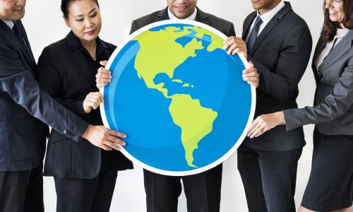 Business people standing and holding globe icon